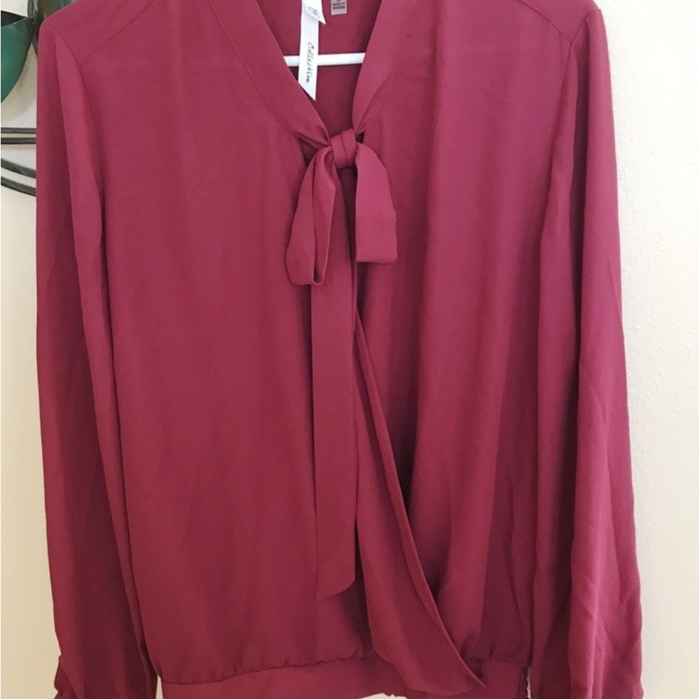 NY Collection high low bow tie blouse w/elastic hem that hugs curves perfectly.